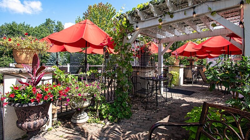 Outdoor dining area with awning and umbrellas