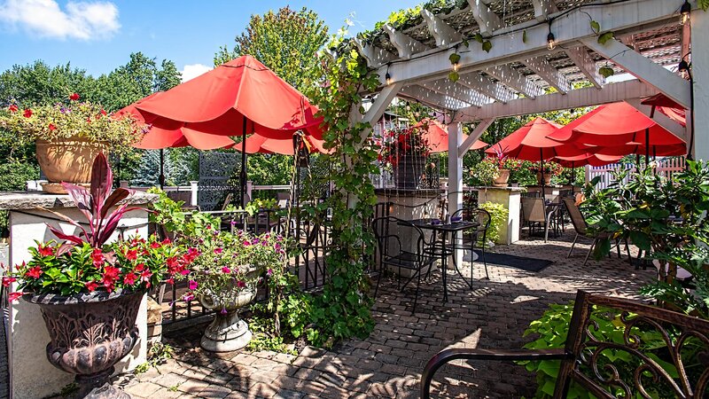 Outdoor dining area with awning and umbrellas - Caffe' Na Vona - Gallery Photo 3 Outdoor dining area with awning and umbrellas